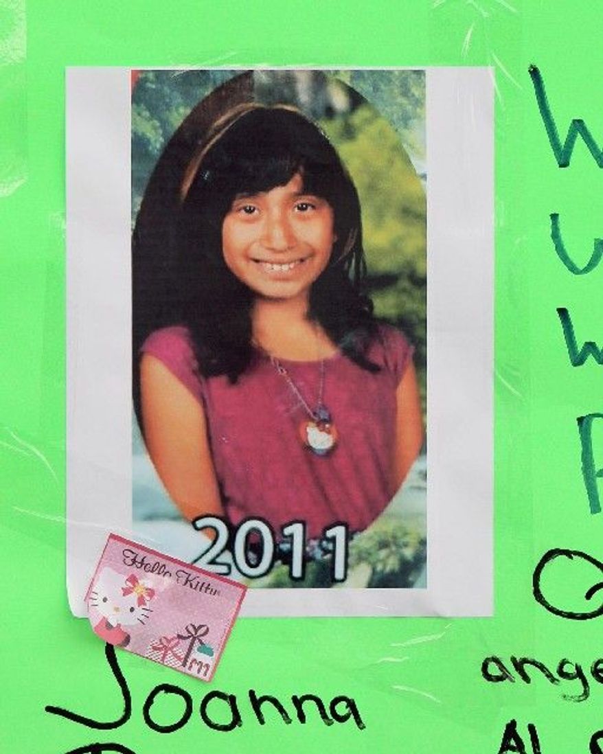 A memorial for Joanna Ramos, 10, stands outside Willard Elementary School in Long Beach, Calif. Joanna died in February after a confrontation with another girl, 11.