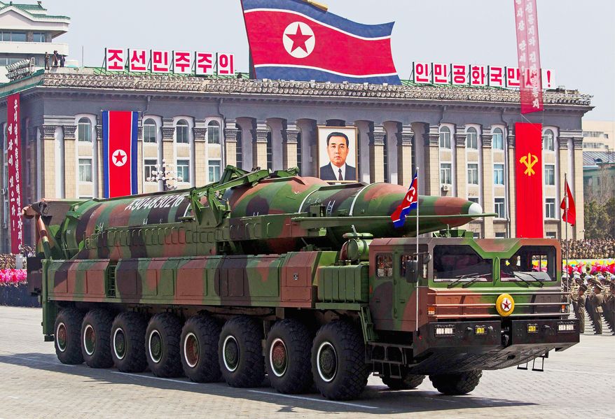 Vehicles transporting North Korean missiles on display over the weekend were made or designed by China, analysts say. Meanwhile, a propaganda billboard in Pyongyang translates as "Let's raise the spirits of winners and build a strong and prosperous nation!" North Korea has yet to launch a multistage missile successfully. (Associated Press)