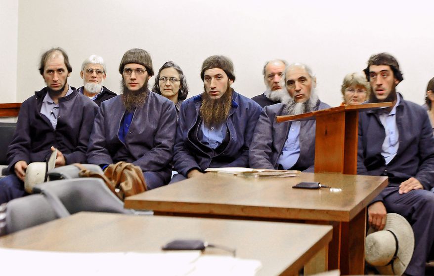 From left, Johnny Mullet, Lester Mullet, Daniel Mullet, Levi Miller and Eli Miller wait to make their pleas in Holmes County Municipal Court in Millersburg, Ohio, in October in the case involving beard- and hair-cutting attacks. (Associated Press)