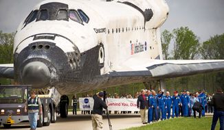 Discovery is towed into place behind the stage to be used as a backdrop during the celebration of its arrival at the Steven F. Udvar-Hazy Center in Chantilly on Thursday. (Rod Lamkey Jr./The Washington Times)
