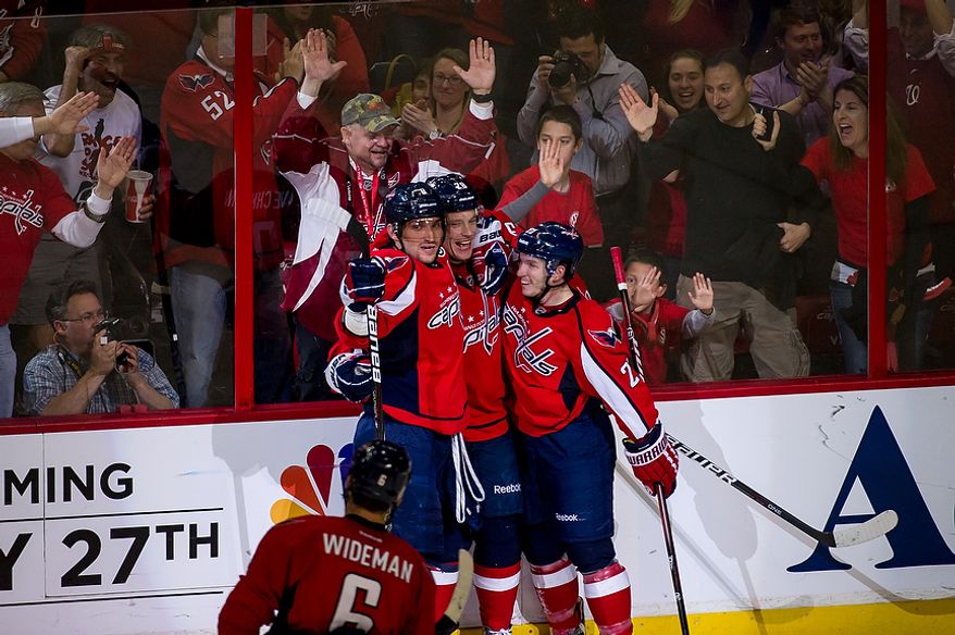 Washington Capitals teammates celebrate as Caps left wing Alexander Semin (28) (second from left) scores to bring the Capitals up 2-1 in the second period as Washington took on the Boston Bruins in game four of the National Hockey League&#x27;s first-round playoffs at the Verizon Center in Washington on Thursday, April 19, 2012. (Andrew Harnik/The Washington Times)
