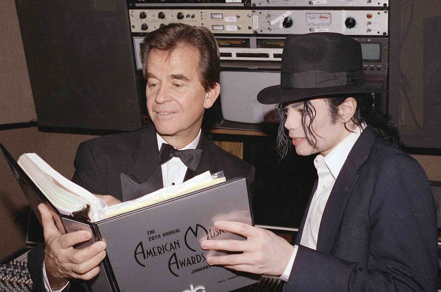 ** FILE ** In this Jan. 24, 1993, file photo, singer Michael Jackson and American Music Awards executive producer Dick Clark go over the script during rehearsals for the American Music Awards at the Shrine Auditorium in Los Angeles. (AP Photo/file)