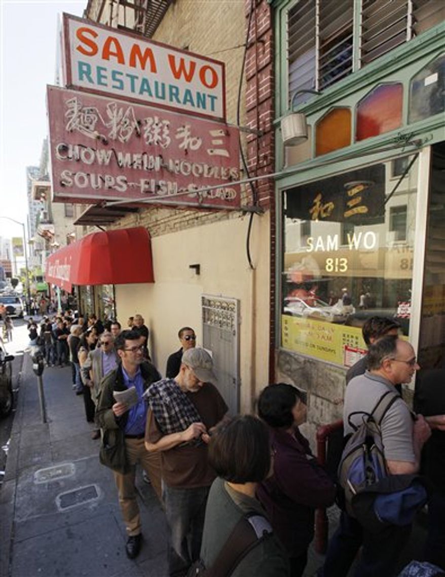 Customers line up for one final meal at the Sam Wo restaurant in Chinatown in San Francisco, Friday, April 20, 2012. The 100-year-old Chinese restaurant known for having "the world's rudest waiter" is shutting its doors and serving its last customers Friday. (AP Photo/Eric Risberg)