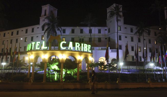 Pedestrians pass the Hotel Caribe in Cartagena, Colombia, late on Thursday, April 19, 2012. U.S. Secret Service employees and military personnel were accused of misconduct in connection with a prostitution scandal at the hotel before President Obama&#x27;s arrival for the Summit of the Americas. (AP Photo/Pedro Mendoza) ** FILE **