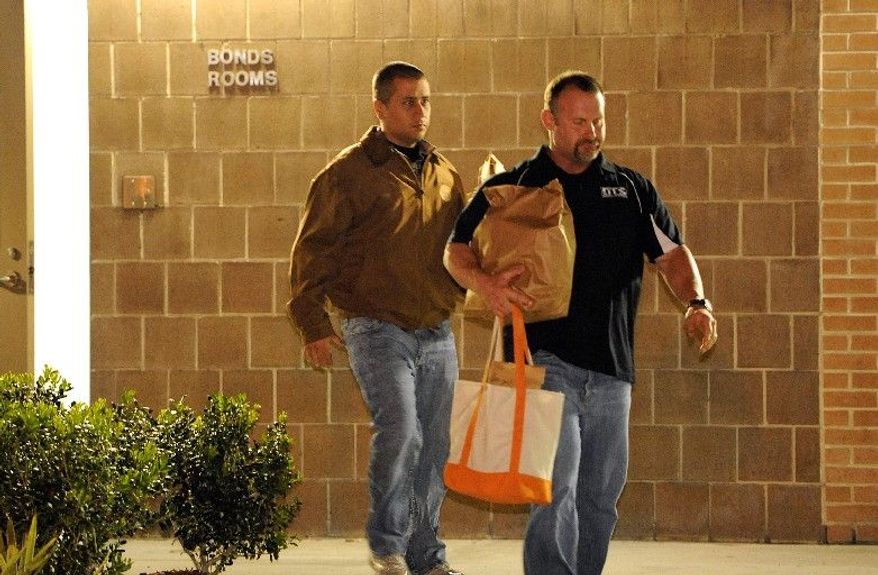 George Zimmerman (left) exits the John E. Polk Correctional Facility, accompanied by a bondsman, on Sunday in Sanford, Fla. Mr. Zimmerman posted bail on a second-degree murder charge in the February shooting death of 17-year-old Trayvon Martin, but he was fitted with a monitoring device when he was released. (Associated Press)
