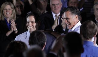 Republican presidential candidate, former Massachusetts Gov. Mitt Romney is joined by Sen. Marco Rubio, R-Fla., during a town hall-style meeting in Aston, Pa., Monday, April 23, 2012. (AP Photo/Jae C. Hong)
