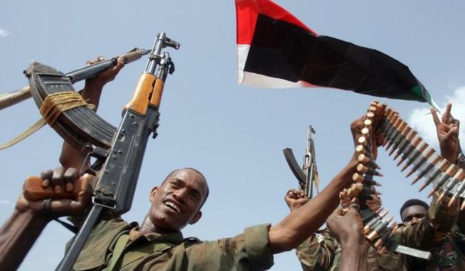 Members of the Sudanese armed forces raise their weapons during a visit by President Omar al-Bashir in Heglig, Sudan, on Monday, April 23, 2012. (AP Photo)