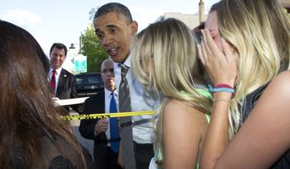 President Obama reacts to having frozen yogurt spilled on his pants as he was greeting the crowd outside the Sink restaurant on Tuesday, April 24, 2012, in Boulder, Colo. (AP Photo/Carolyn Kaster)