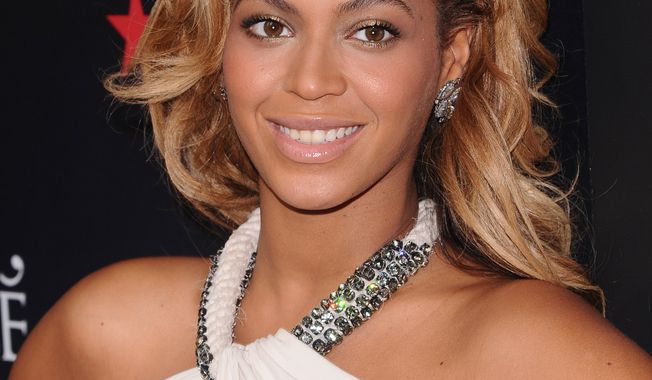 **FILE** Singer Beyonce Knowles makes an appearance at Macy's Herald Square on Sept. 22, 2011, to promote her new fragrance 'Pulse' in New York. (Associated Press)