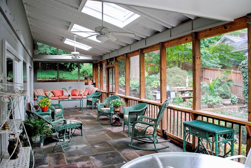 The 450-square-foot screened porch has a slate floor, skylights, a ceiling fan and overlooks a patio and terraced garden.