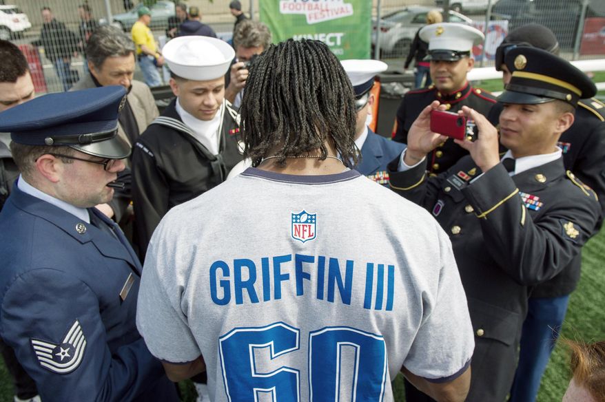 Griffin signs autographs Wednesday for members of the New York City Joint Service Color Guard after he participated in a Play 60 event in Chelsea. (Andrew Harnik/The Washington Times)