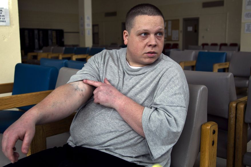 **FILE** Inmate Steve Wohlen displays heroin needle tracks in his arm April 12, 2012, during an Associated Press interview in a state prison, in Bridgewater, Mass. Wohlen was saved from a life-threatening heroin overdose in 2010 by his mother when she applied two quick sprays of Narcan, a drug that blocks opioid receptors in the brain to reverse overdoses of opiates. (Associated Press)