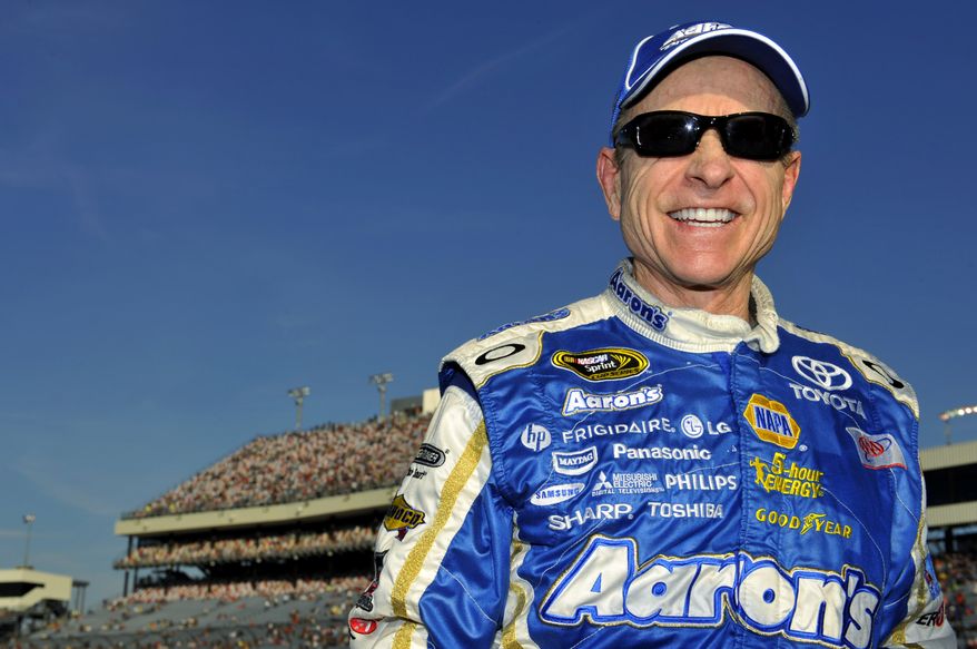 Mark Martin smiles after winning the pole during qualifying for Saturday's NASCAR Sprint Cup Series auto race at Richmond International Raceway, Friday, April 27, 2012, in Richmond, Va. (AP Photo/Autostock, Nigel Kinrade)