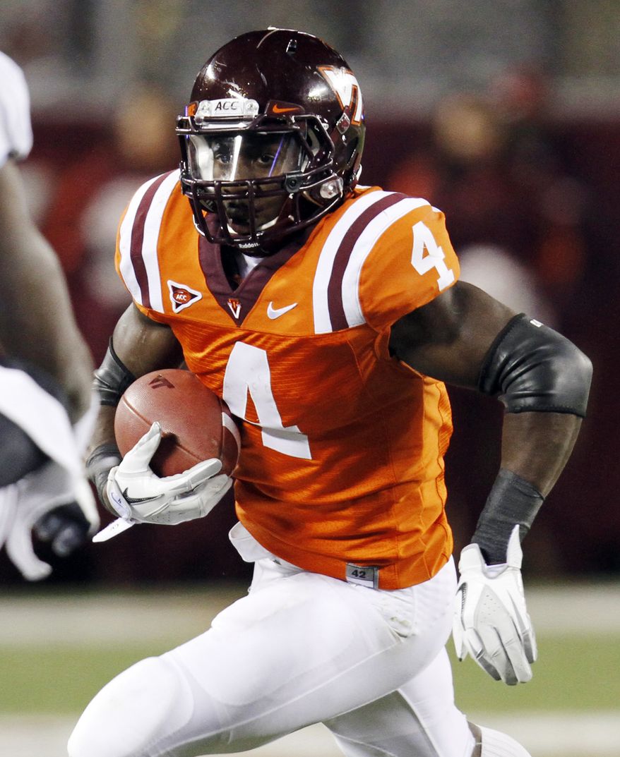 FILE - In this Nov. 17, 2011, file photo, Virginia Tech running back David Wilson (4) looks for room during the first half of an NCAA college football game against North Carolina in Blacksburg, Va. Wilson was selected as the 32nd pick overall by the New York Giants in the first round of the NFL football draft at Radio City Music Hall, Thursday, April 26, 2012, in New York. (AP Photo/Steve Helber, File)