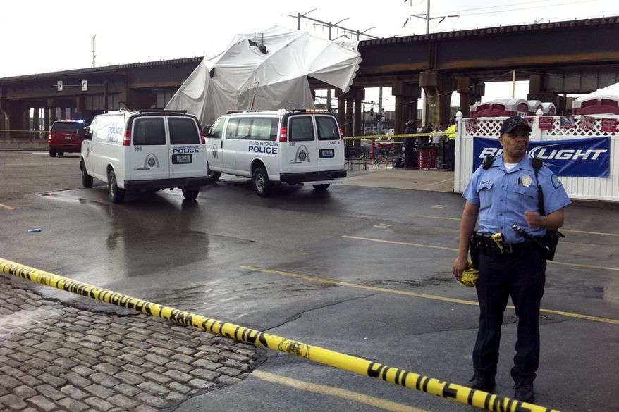 Officials respond to the scene where a tent blew over after high winds crossed the area, Saturday, April 28, 2012, in St. Louis. The tent was set up next to Kilroy's Sports Bar, where St. Louis Fire Chief Dennis Jenkerson said a few hundred people were celebrating after the St. Louis Cardinals defeated the Milwaukee Brewers 7-3 in a baseball game. Emergency officials said 16 people were taken to hospitals with injuries ranging from minor to very serious. KSDK reported that fire officials said five people were in critical condition and 100 people were treated at the scene. (AP Photo/St. Louis Post-Dispatch, Emily Rasinski)