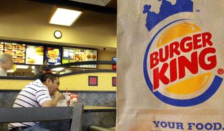 A customer chows down at a Burger King in Springfield, Ill. The No. 3 fast-food chain has announced that all of its eggs and pork will come from cage- and crate-free chickens and pigs by 2017, raising the bar for its rivals. (Associated Press)