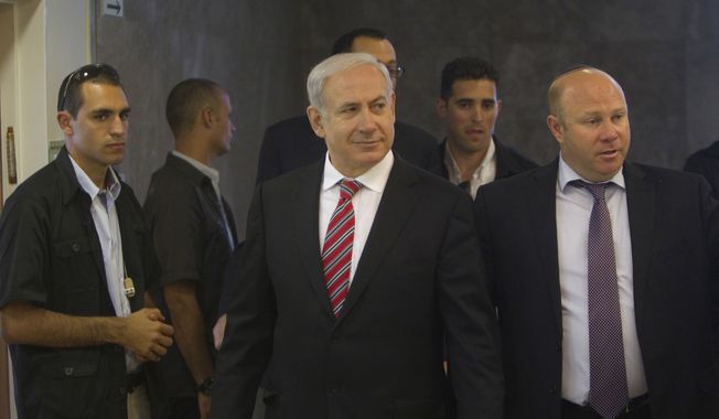 Israeli Prime Minister Benjamin Netanyahu (center) arrives for the weekly Cabinet meeting in Jerusalem on Sunday, April 29, 2012. (AP Photo/Ronen Zvulun, Pool)