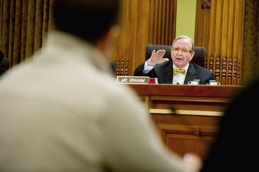 Inside, council member Jim Graham, Ward 1 Democrat, challenges bar and nightclub owners testifying in favor of extending the hours for bars and nightclubs. He proposed a tax increase on alcohol that would offset the added income of the later hours. (Andrew Harnik/The Washington Times)