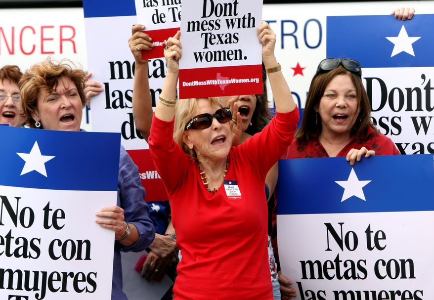 ** FILE ** Protesters rally during Women's Health Express in San Antonio in March to protest the attempt to cut Planned Parenthood out of the Texas Women's Health Program. (Associated Press)