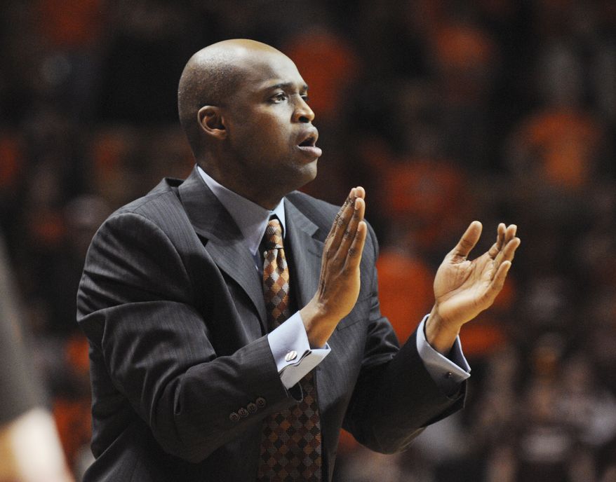 In this Feb. 12, 2012, photo provided by Virginia Tech sports information, Virginia Tech associate head basketball coach James Johnson applauds during the team's game against Boston College in Blacksburg, Va. A person familiar with the talks told The Associated Press on Monday, April 30, 2012, that Johnson will replace Seth Greenberg after serving as his assistant for five years. (AP Photo/Virginia Tech, Michael Shroyer)