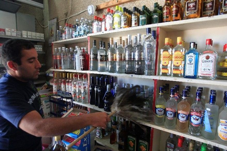 Patrick Kattoura runs his father's liquor store in Tyre that was heavily damaged by a bomb in December. "It is my right to sell whatever I want as long as it does not violate Lebanese laws," he said. (Associated Press)