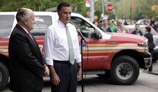 Republican presidential candidate Mitt Romney (right), accompanied by former New York Mayor Rudy Giuliani, talks to reporters in front of Engine 24, Ladder 5, in New York on Tuesday, May 1, 2012. (AP Photo/Jae C. Hong)
