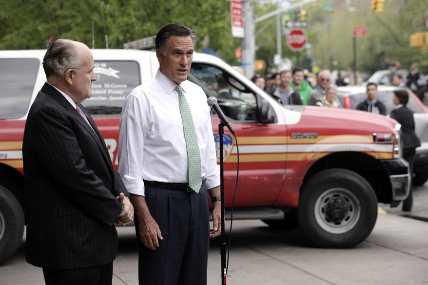 Republican presidential candidate Mitt Romney (right), accompanied by former New York Mayor Rudy Giuliani, talks to reporters in front of Engine 24, Ladder 5, in New York on Tuesday, May 1, 2012. (AP Photo/Jae C. Hong)