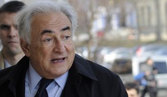 Former International Monetary Fund leader Dominique Strauss-Kahn enters a building before his lecture at the Ukrainian Diplomatic Academy in Kiev on April 4, 2012. (AP Photo/Sergei Chuzavkov)

