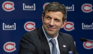 Marc Bergevin smiles as he is introduced as the Montreal Canadiens&#39; new general manager Wednesday, May 2, 2012 in Brossard, Quebec. (AP Photo/The Canadian Press, Paul Chiasson)