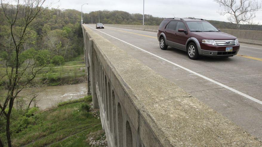 Cars travel on Ohio state Route 82 across a bridge over the Cuyahoga Valley National Park in Brecksville, Ohio, on May 1, 2012. Five men were arrested the previous night for conspiring to blow up the bridge. (Associated Press)