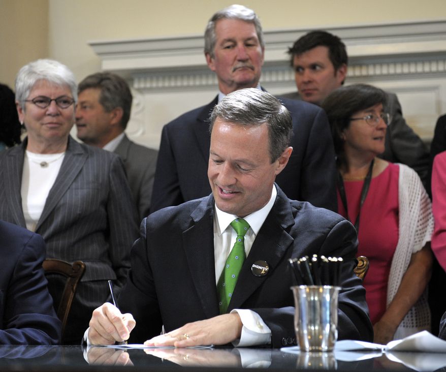 Maryland Gov. Martin O'Malley signs one of approximately 300 bills at the State House in Annapolis, Wednesday, May 2, 2012. (AP Photo/Cliff Owen)