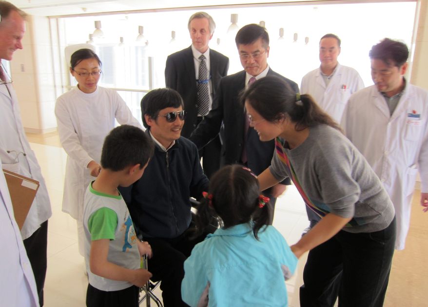 Blind dissident lawyer Chen Guangcheng meets with wife Yuan Weijing, daughter Chen Kesi and son Chen Kerui at a hospital in Beijing on Wednesday, May 2, 2012. Gary Locke, U.S. ambassador to China, is at Mr. Chen's side, as is language attache James Brown (center background). (U.S. Embassy, Beijing, via Associated Press)