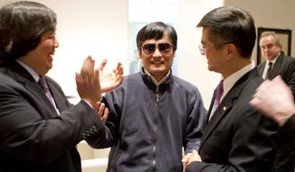 Blind lawyer Chen Guangcheng (center) holds hands with Gary Locke (right), U.S. Ambassador to China, as U.S. State Department Legal Advisor Harold Koh applauds May 2, 2012, before Chen left the U.S. embassy for a hospital in Beijing. (Associated Press/U.S. Embassy Beijing Press Office)