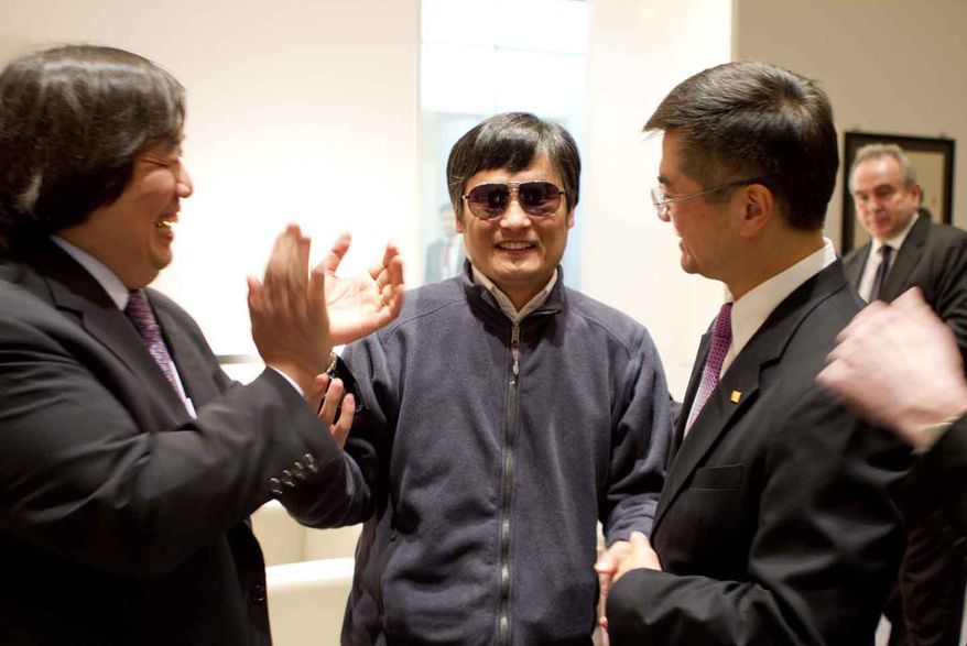 Blind lawyer Chen Guangcheng (center) holds hands with Gary Locke (right), U.S. Ambassador to China, as U.S. State Department Legal Advisor Harold Koh applauds May 2, 2012, before Chen left the U.S. embassy for a hospital in Beijing. (Associated Press/U.S. Embassy Beijing Press Office)