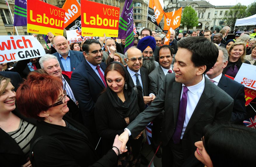 Labour Party leader Ed Miliband shakes hands with wellwishers in Birmingham, England, Friday May 4, 2012. Prime Minister David Cameron's Conservative Party took an electoral bruising Friday, suffering widespread losses in local elections as voters punished the leader for biting austerity measures and a stalled economy. Main opposition Labour Party leader Ed Miliband toasted his own party's revival after its ousting from national office in the 2010 national election. By Friday morning it had won control of 22 local authorities and claimed at least 470 new council seats. (AP Photo/PA, Rui Vieira)