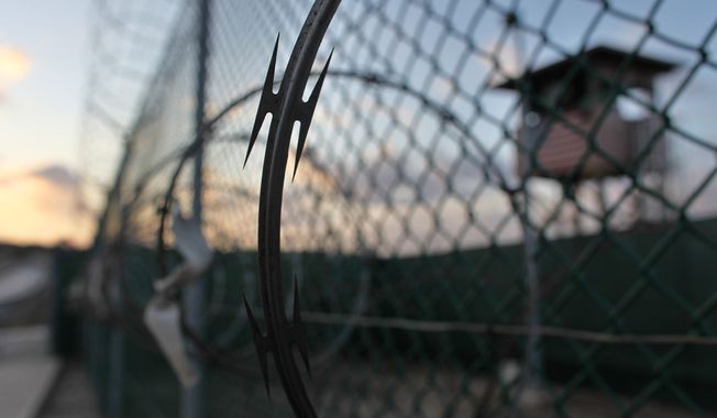 **FILE** The sun rises May 13, 2009, over the Guantanamo detention facility at the Guantanamo Bay U.S. Naval Base, Cuba. (Associated Press)