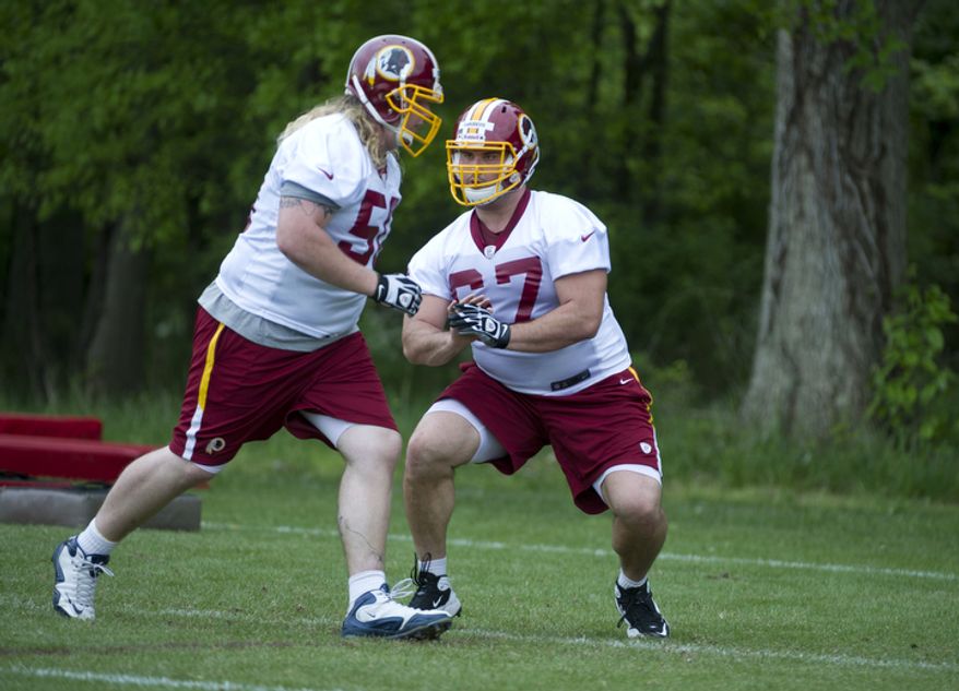 Josh LeRibeus, right, an offensive guard drafted from SMU, goes through blocking drills at Redskins Park. (Barbara L. Salisbury/The Washington Times)