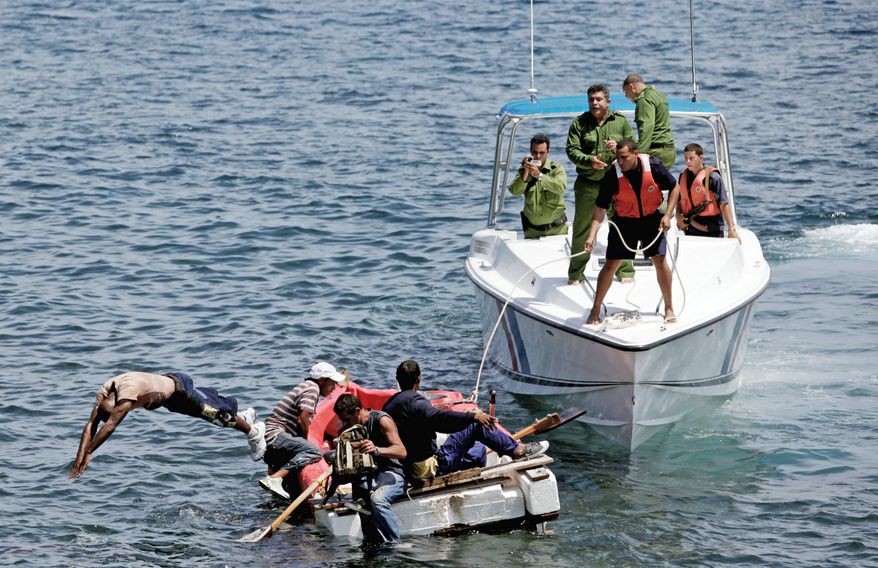 In this June 4, 2009 file photo, Cuban coast guards, right, stop men from trying to migrate illegally to the U.S. on a foam raft near Havana's Malecon. Cuba's government appears on the verge of a momentous decision that could end a half-century of travel restrictions that make it difficult to leave the Communist-run island, even for vacation. (AP Photo/Javier Galeano, File)