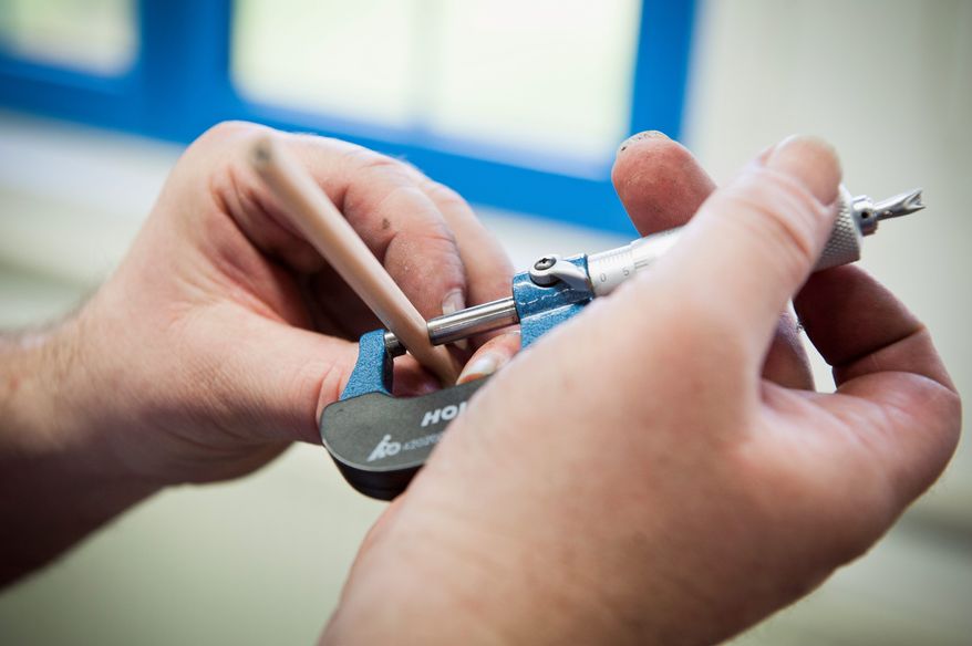 Faber-Castell employee Wolfgang Mattner checks production quality by measuring a pencil that came off the line at the factory in Stein, near Nuremberg. Faber-Castell makes pens, pencils and other office and art supplies, as well as high-end writing instruments and luxury leather goods. (Christian Burkert/Special to The Washington Times)
