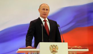 Vladimir Putin speaks with his hand on the Russian Constitution during his inauguration ceremony as the country&#39;s president in Moscow on Monday, May 7, 2012. (AP Photo/RIA Novosti Kremlin, Vladimir Rodionov, Presidential Press Service)

