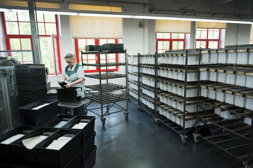 Faber-Castell employee Jeane Pufala takes pencils out of a hanger after they've dried at the pencil factory in Stein, near Nuremberg in Germany. Faber-Castell is one of the world's largest manufacturers of pens, pencils, and other office supplies and art supplies. (Christian Burkert/Special to The Washington Times)