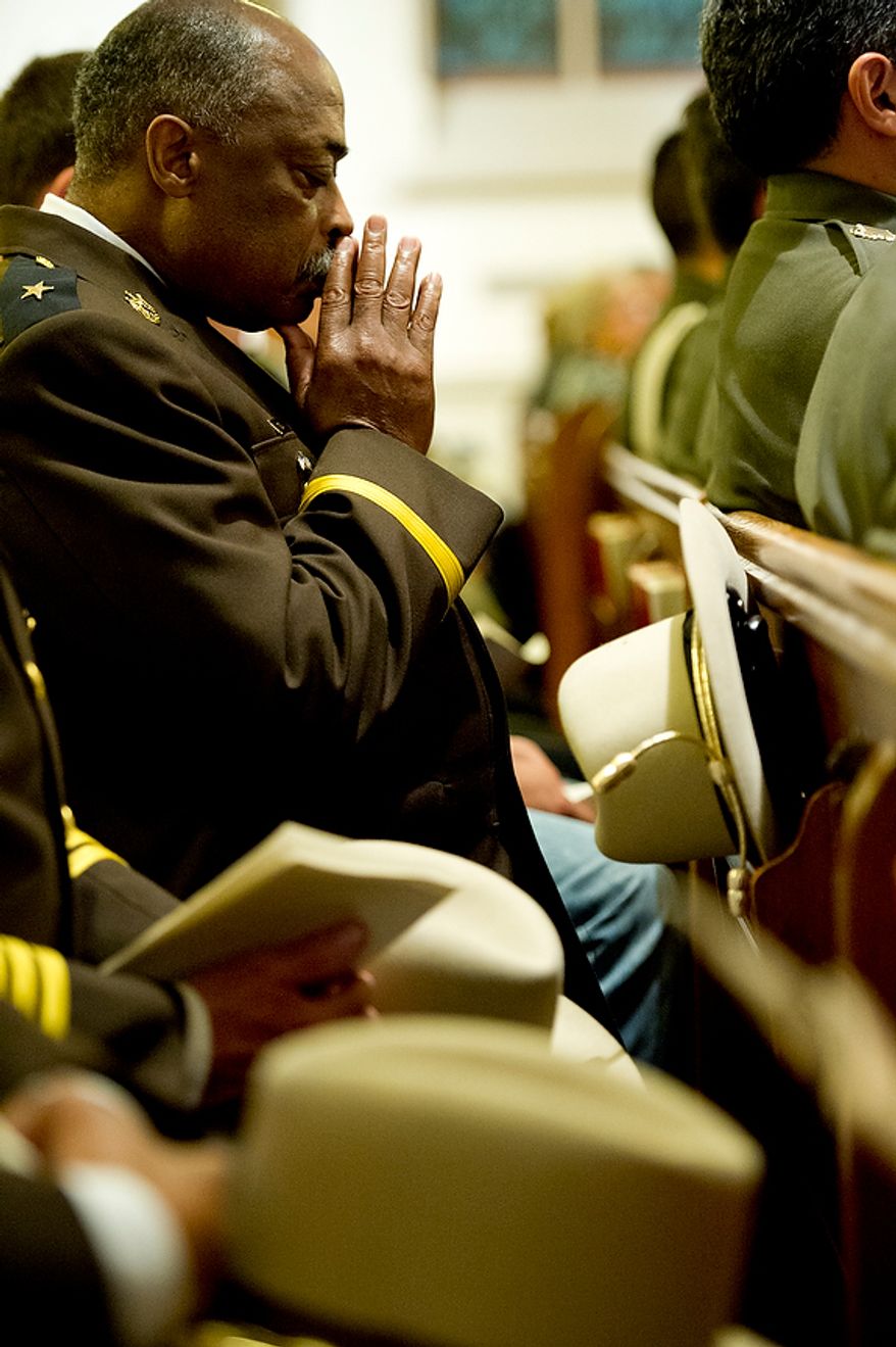 Prince George's County Sheriff Melvin High prays following communion at the annual Blue Mass honoring law enforcement and public safety officials Tuesday, May 8, 2012 at St. Patrick's in the City in Northwest Washington, D.C. (Barbara L. Salisbury/The Washington Times)