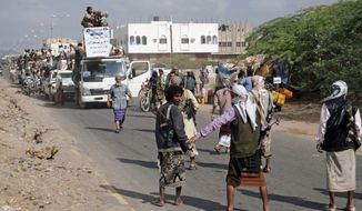 **FILE** Yemeni residents, who fled nearly eight months of fighting between the army and Islamists, return home in Zinjibar, Yemen, on Jan. 14, 2012. (Associated Press)