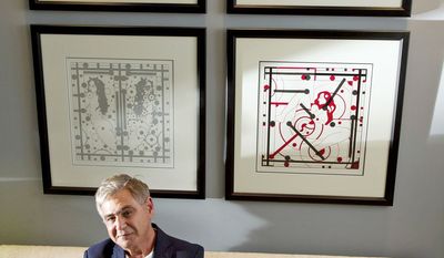 Charles Krause, a former international correspondent, starting collecting political artwork in his travels. Now he runs the Charles Krause/Reporting Fine Art gallery out of his condominium in downtown Washington. Behind him are works by Leonhard Lapin. (Barbara L. Salisbury/The Washington Times)
