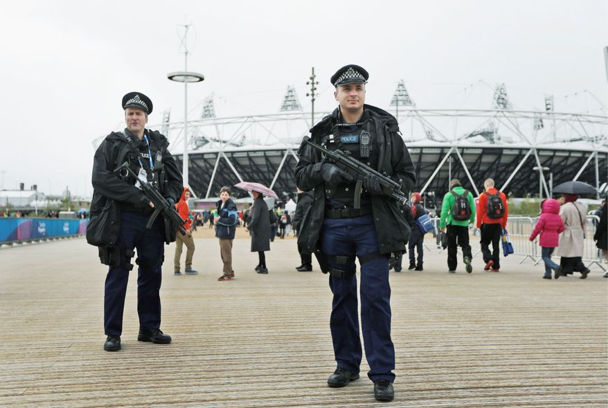 Police officers are ready outside the Olympic Stadium in London. They are part of the United Kingdom's largest ever peacetime security operation. (Associated Press)