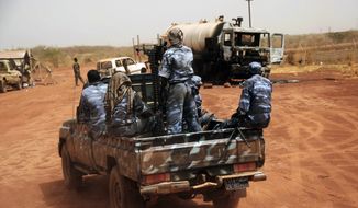 **FILE** Sudanese armed forces ride a military vehicle April 24, 2012, at the oil-rich border town of Heglig, Sudan. (Associated Press)