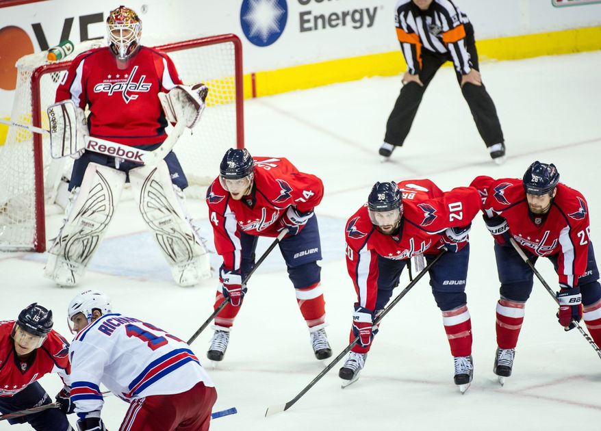Capitals John Carlson (left), Troy Brouwer (center) and Matt Hendricks aligned to the side of goalie Braden Holtby before a third-period faceoff during Game 6 on Wednesday at Verizon Center. Washington won 2-1 to send the Eastern Conference semifinal series to a decisive game Saturday night in New York. (Andrew Harnik/The Washington Times)