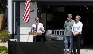 President Barack Obama, accompanied by Val and Paul Keller, talks about home mortgages, Friday, May 11, 2012, outside the Kellers home in Reno, Nev. Obama met with the Kellers who recently refinanced their home loan under a federally backed program that the President wants to expand to all homeowners who are paying their mortgages on time.(AP Photo/Rich Pedroncelli)