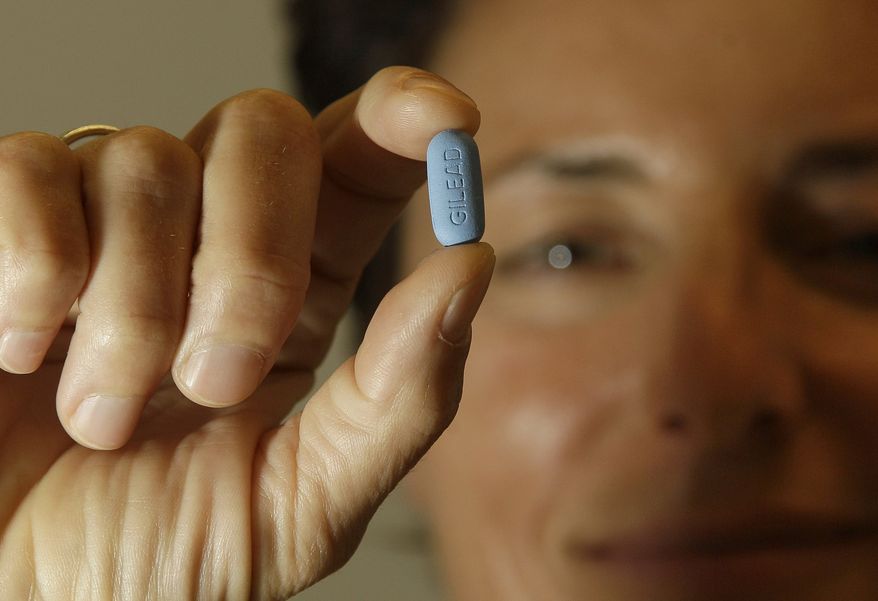 Dr. Lisa Sterman holds up a Truvada pill at her office in San Francisco on May 10, 2012. The pill, already used to treat people with HIV, also helps prevent the virus from infecting healthy people. (Associated Press)