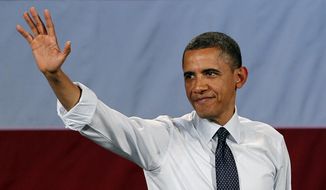 President Obama waves May 10, 2012, as he leaves the stage after speaking at a fundraising event in Seattle. (Associated Press)